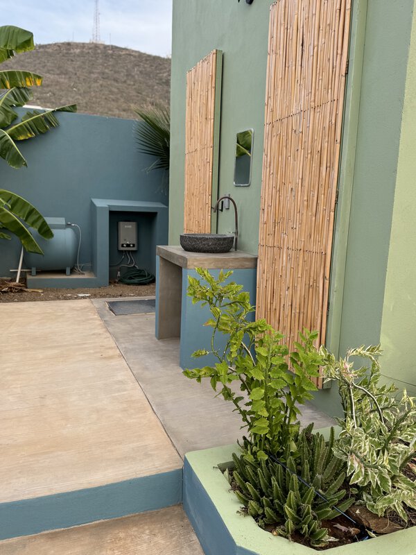 Picture of the doors and sink at the bathroom facilities at a trailer park in El Pescadeo, Southern Baja, Mexico. Pictured are the to bamboo doors which open to the toilet and hot shower facilities.