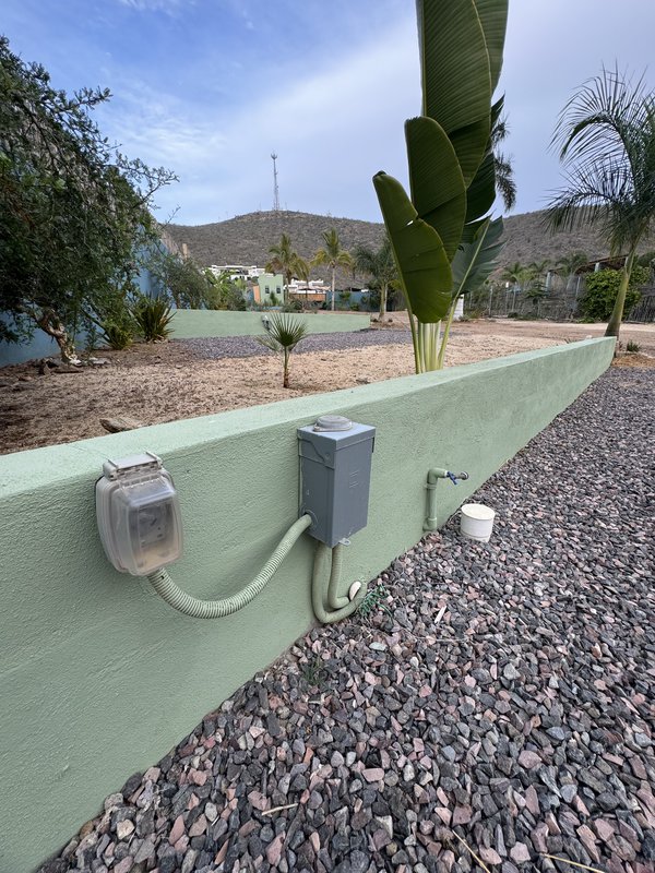 picture of the hook up facilities available at Oasis Azul RV Park. Pictured is the power plug in box, the fresh water supply, and the sewer waste hook up. Located in Baja Sur, Mexico